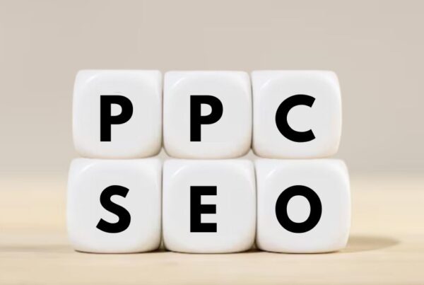 SEO and PPC written on a white plain dice having cream color background