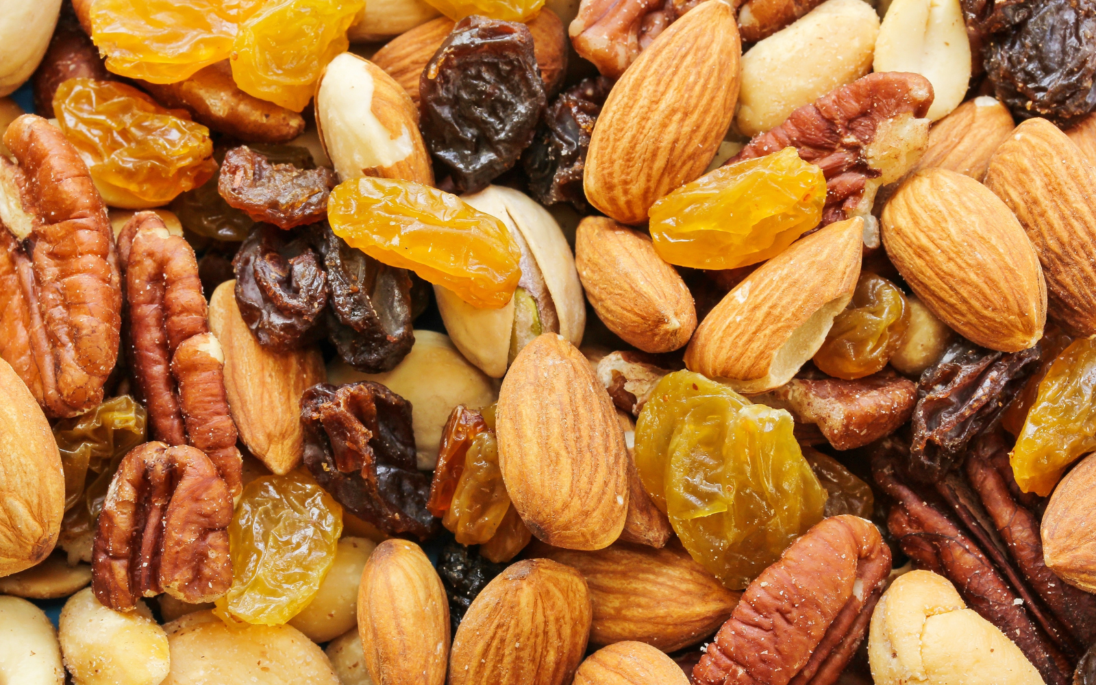 mixed dryfuits are spreaded on a plain surface dryfruits ecommerce website portfolio